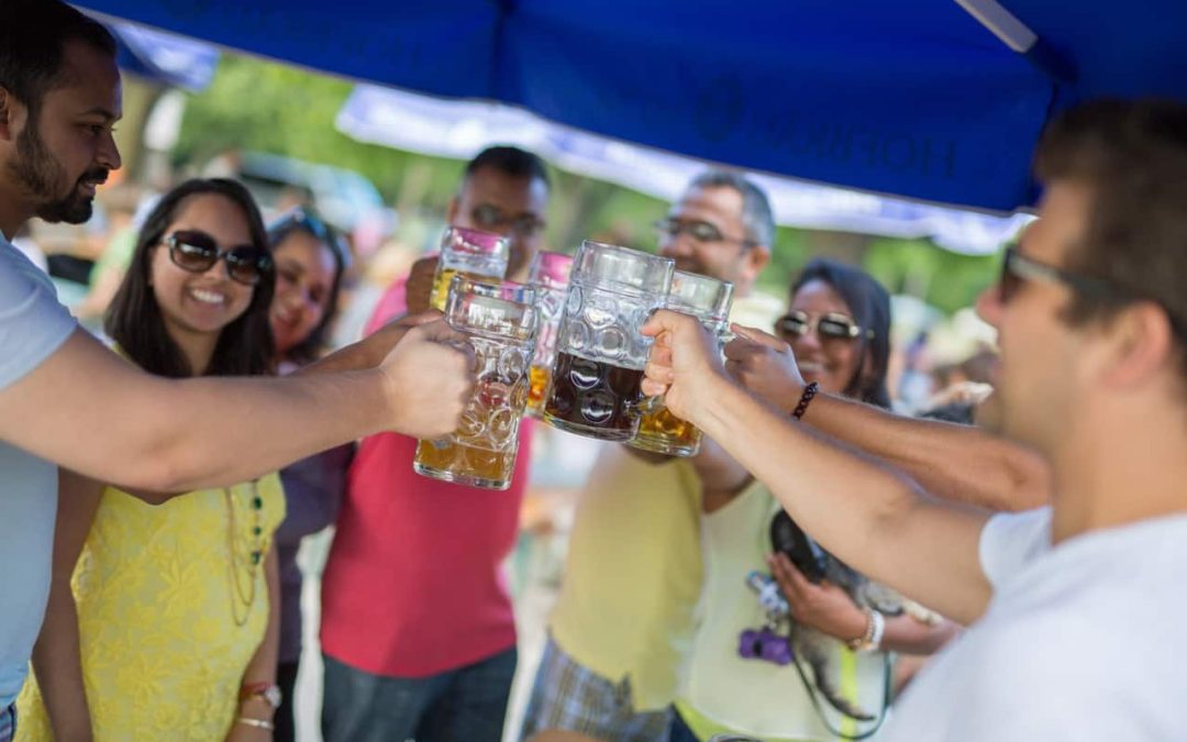 Group holding beer steins